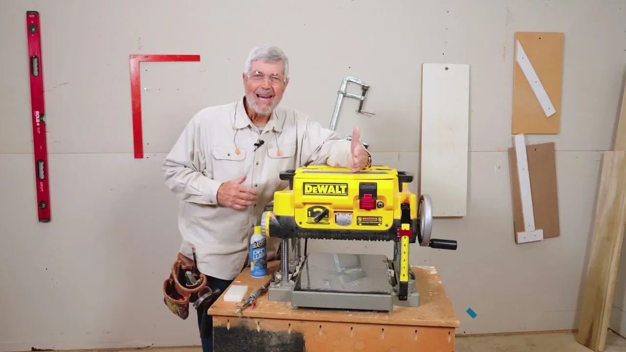 Trim carpenter Gary Striegler in his shop beside a benchtop planer